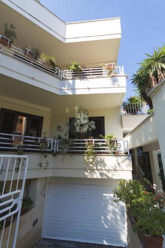 a white house with a garage with potted plants at B&B Luxury in Lecce