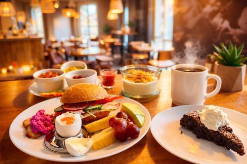a table topped with plates of food and coffee at Hotell Siesta in Karlskrona