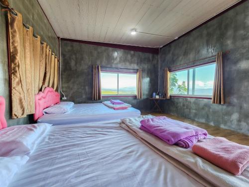 En eller flere senge i et værelse på Munli Homestay