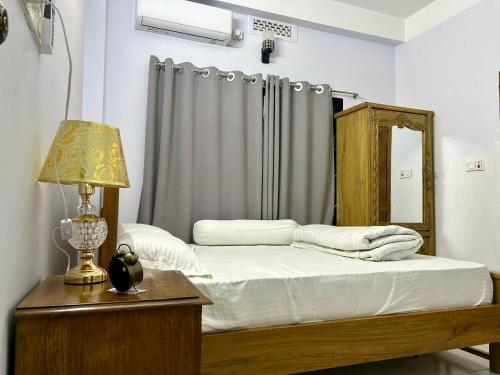 En eller flere senge i et værelse på Sribhumi Homestay Sreemangal