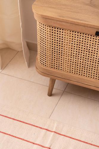 a wicker table and a wicker stool in a bathroom at The 764 Residence - Kalavryta Town center in Kalavrita