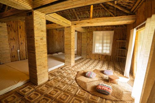 a room with a bed in a wooden house at Lagom Village-Glamping Site- Đồng Đò lake view in Hanoi