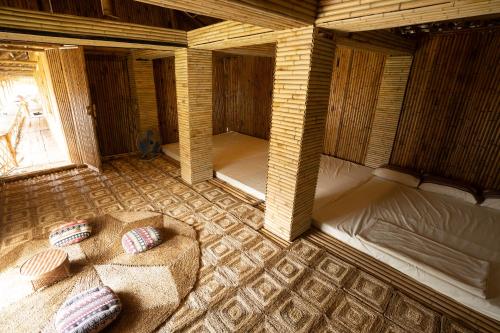 a room with two beds and a couch in it at Lagom Village-Glamping Site- Đồng Đò lake view in Hanoi