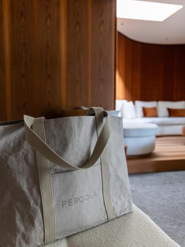 a gray bag sitting on top of a couch at Pergola Residence in Lagundo
