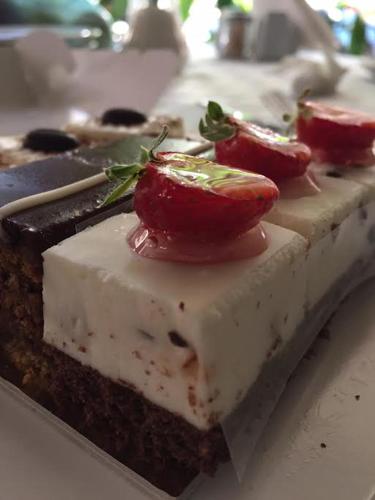 a piece of cake with tomatoes on top of it at Art 'Otel in Sofia