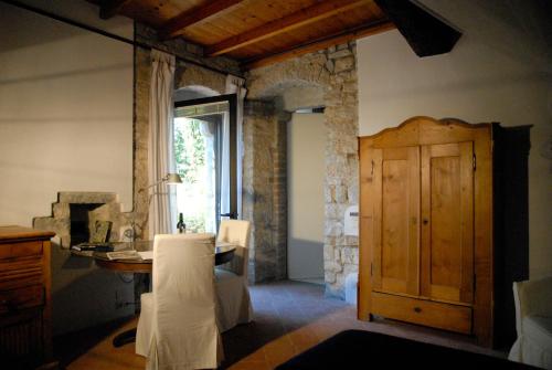 SettignanoにあるVilla Palagioのテーブル、窓、デスクが備わる客室です。