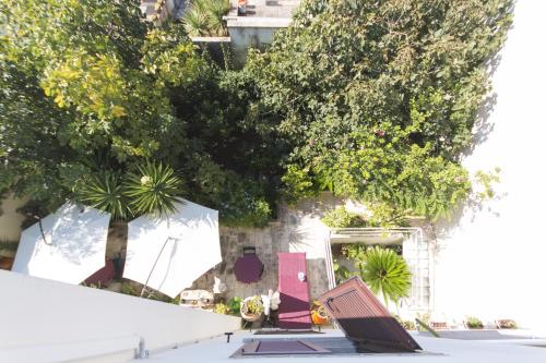 a bench in front of a building with trees at B&B Luxury in Lecce