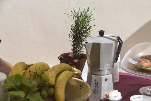 a bunch of bananas and grapes on a table at B&B Luxury in Lecce