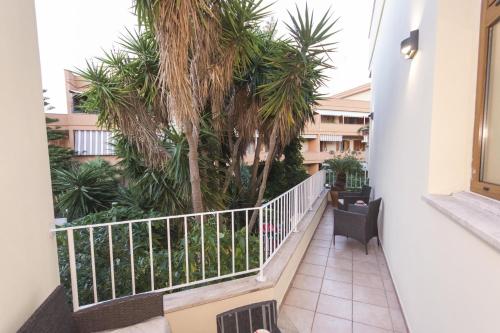 a balcony of a building with palm trees at B&B Luxury in Lecce