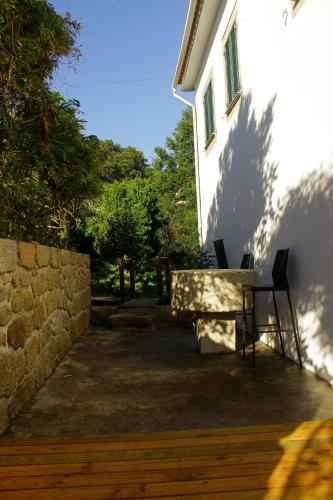 a table and chairs sitting outside of a building at Moinho do Prado in Vila Nova de Cerveira