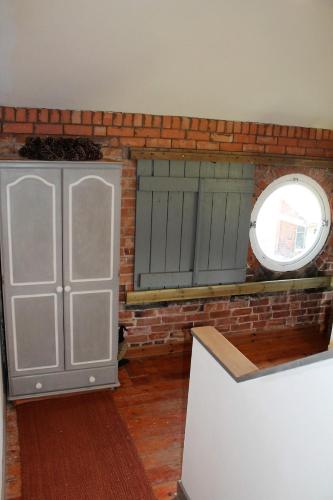 a room with two green doors and a window at The Jockey Room Hideaway in Spurstow
