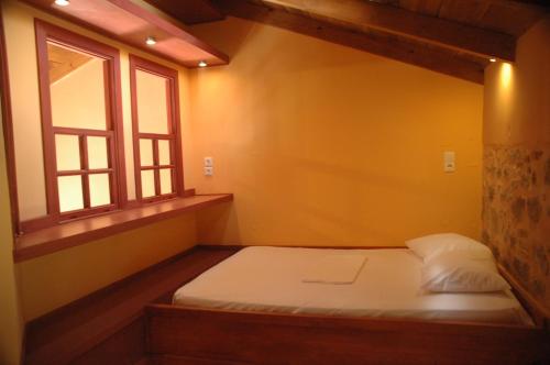 En eller flere senger på et rom på Villa Daphnis & Chloe