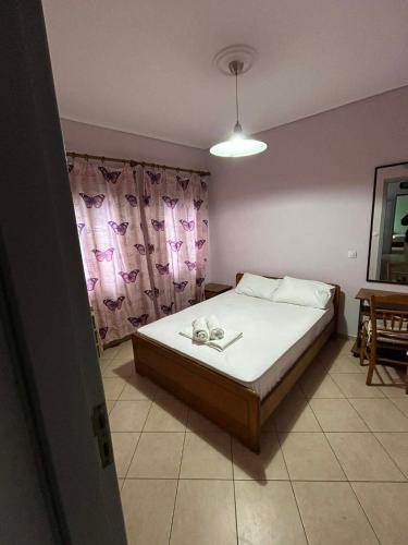 a bedroom with a bed and a window at Family House with Sea View in Marathokampos