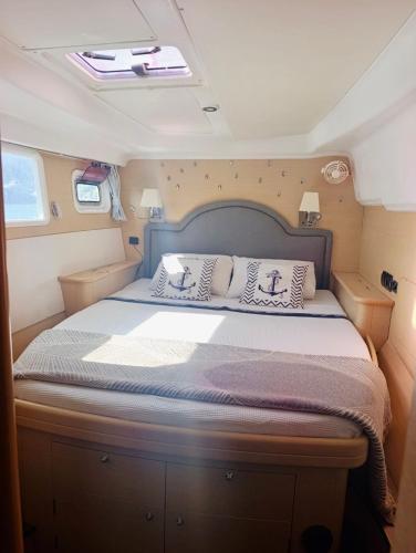 a bed in the middle of a room at catamaran yatch tour in Göcek