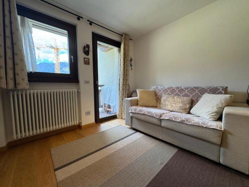 a living room with a couch and a window at Suite Panorama in Valdisotto
