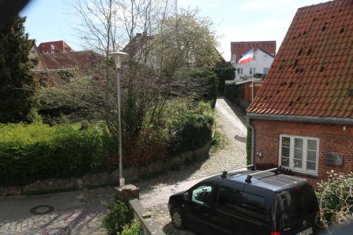 een zwart busje geparkeerd voor een huis bij Ferienwohnungen am Schwanensee in Plön