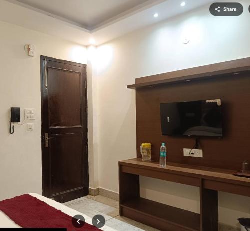 a hotel room with a television and a bed at Star hill in Rishīkesh