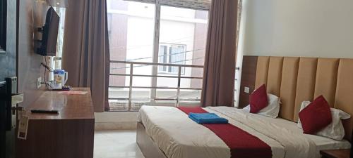 a hotel room with a bed and a window at Star hill in Rishīkesh