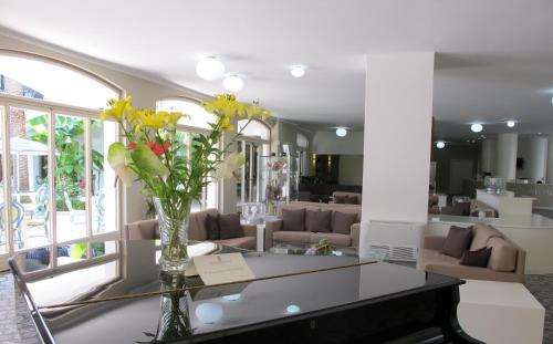 a living room filled with furniture and flowers at Grand Hotel Don Juan in Giulianova
