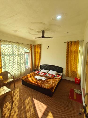 a bedroom with a bed in a room with curtains at The Atiq Stay in Jāmb