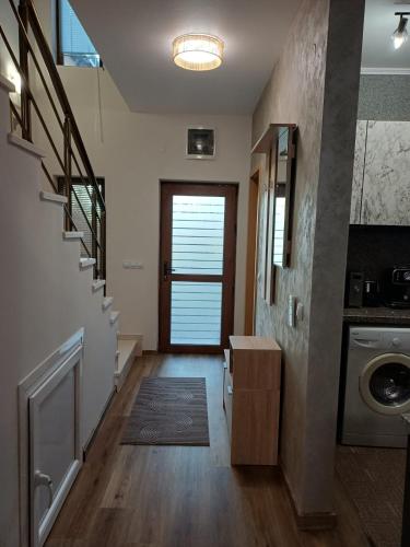 a hallway with a staircase and a door with a washer at Къща за гости Форест 58 in Vasil Levski
