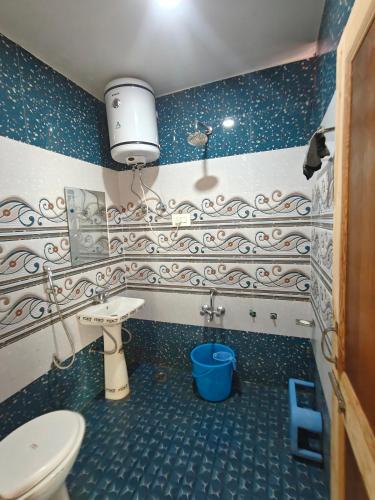 a bathroom with a toilet and a sink at The Atiq Stay in Jāmb