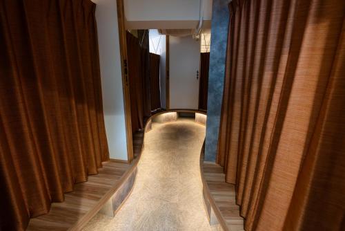a hallway with brown curtains and a long aisle at Wa Hostel in Tokyo