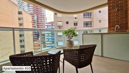 a balcony with a table with a potted plant on it at Book Santos - Apartamentos no Unique Residence in Santos