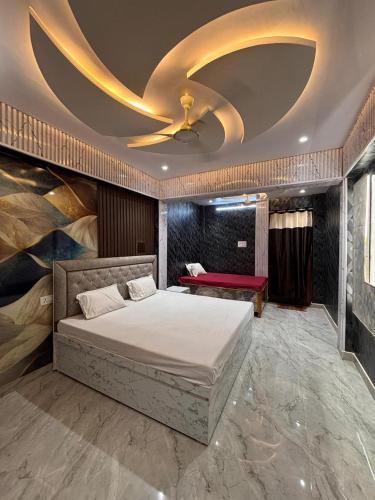 a bedroom with a bed with a ceiling fan at Hotel Nav Prayag Inn in Prayagraj