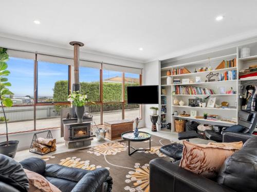 a living room with a couch and a fire place at Inn Seaclusion in Devonport