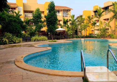 a swimming pool in the middle of a resort at Goa stays in Anjuna