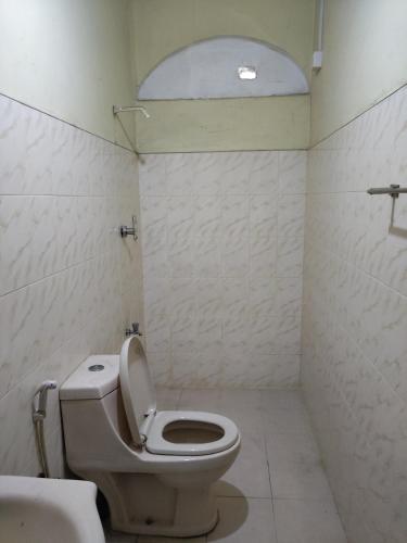 a bathroom with a toilet and a sink at Foreign Home Stay in Katugastota