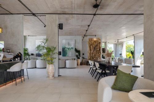 a living room with a table and chairs at Hidden City Ubud - Modern Comfort & Relaxed Living near Central Ubud and Green Fields in Ubud