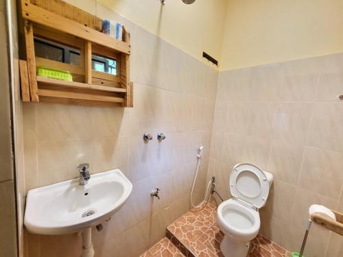 a bathroom with a toilet and a sink at Jangwani Riverview Suits in Mto wa Mbu