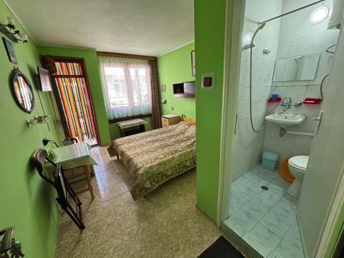 a bathroom with a bed and a sink and a shower at Dom Lidiya in Pomorie