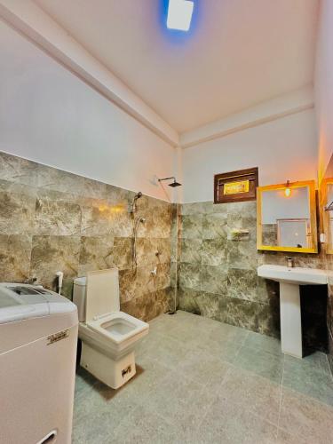 a bathroom with a toilet and a sink at In Dream Villa in Rekawa