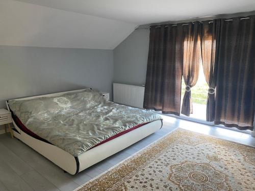 a bedroom with a bed and a large window at Murat villa in SJJ