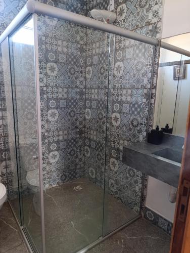 a bathroom with a shower with a toilet and a sink at Divas do mar kitnet 7 in Ilhéus