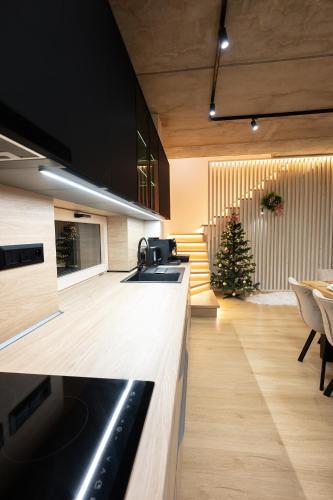 a kitchen with a counter and a christmas tree at Chalet Horizont in Ižipovce