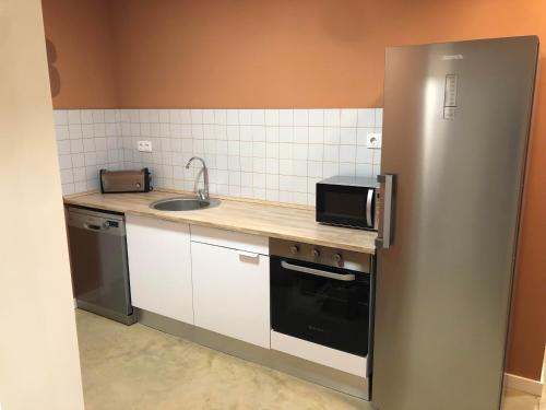 a small kitchen with a sink and a microwave at Lemon Hostel in Altea