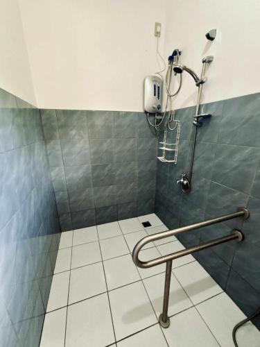 a shower in a bathroom with a tiled floor at LUZVILLE Transient House - Port Barton in Itaytay