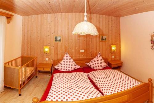 a bedroom with two beds with red and white pillows at Hauser Hof Grübl in Waldkirchen