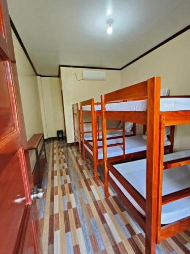 a room with three bunk beds in it at CocoVille Guesthouse Barkada Room in Alegria