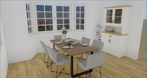 una sala da pranzo con tavolo e sedie in legno di Reetruhe a Goting