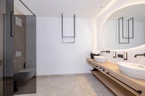 a bathroom with two sinks and a mirror at my Zillernest in Zell am Ziller
