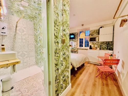 a room with a bed and a table and chairs at RB Portobello in London