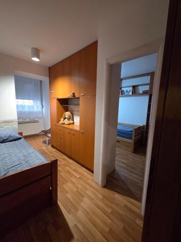 a bedroom with a bed and wooden cabinets at Apartment SOFI Novi Travnik in Novi Travnik