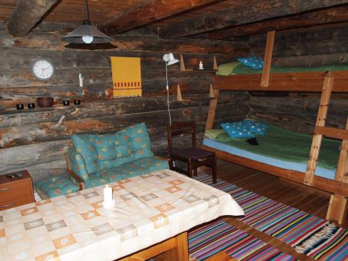 a living room with two bunk beds and a table at Ahkun Tupa in Lemmenjoki