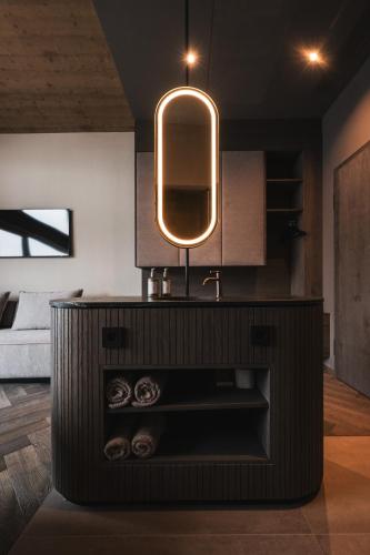 a bathroom with a sink and a mirror at Alpine Boutique Hotel wollée - 4 Star Superior in Schladming