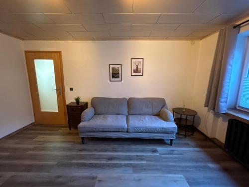 a living room with a couch and a table at Hotel Mühlental in Wernigerode